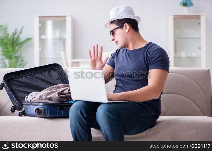 Man booking online his travel flight and hotel