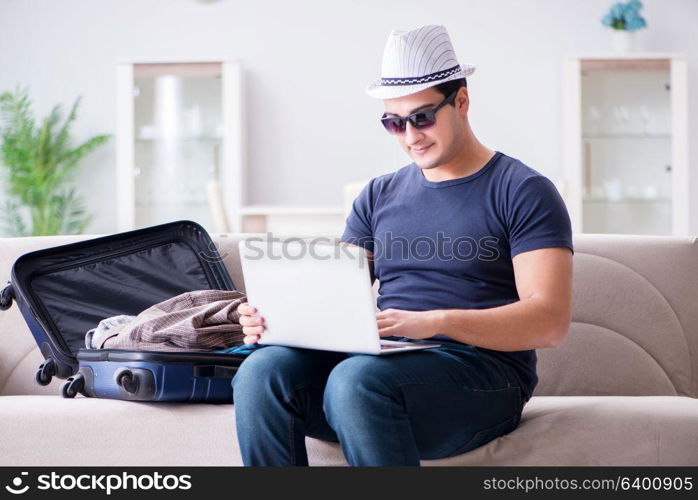 Man booking online his travel flight and hotel