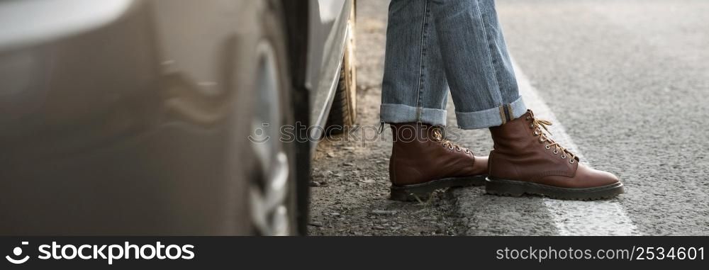 man boots car while road trip