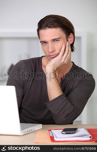 Man bored working at home