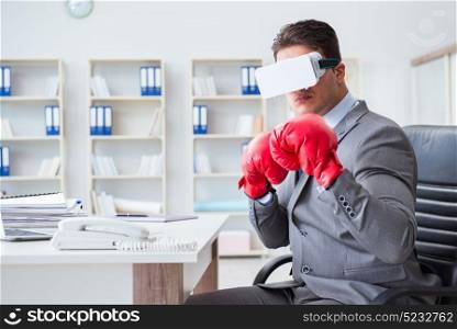 Man boxing in the office with virtual reality goggles