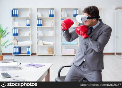 Man boxing in the office with virtual reality goggles. The man boxing in the office with virtual reality goggles