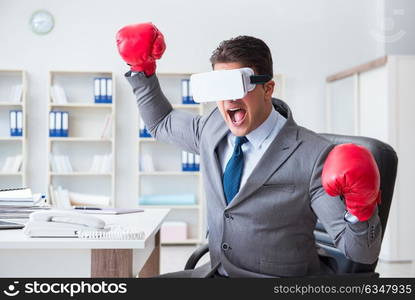 Man boxing in the office with virtual reality goggles