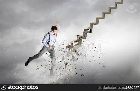 Man breaking ladder. Young businessman crashing stone staircase representing success concept