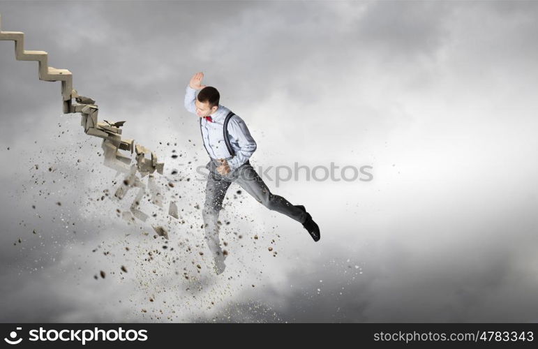 Man breaking ladder. Young businessman crashing stone staircase representing success concept