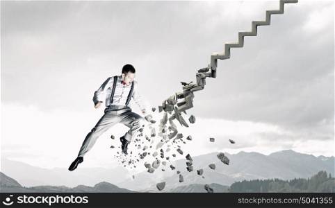 Man breaking ladder. Young businessman crashing stone staircase representing success concept