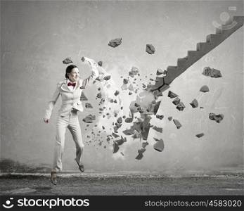 Man breaking ladder. Young businesswoman crashing stone staircase representing success concept