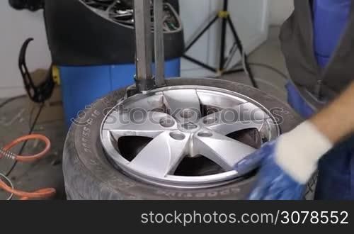 Man Breaking The Tire Off From The Rim by special tool,