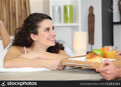 Man bringing breakfast to girlfriend