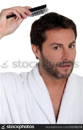 Man brushing his hair