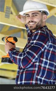man builder drilling screws in ceiling
