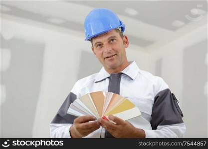 man builder holding a color swatch