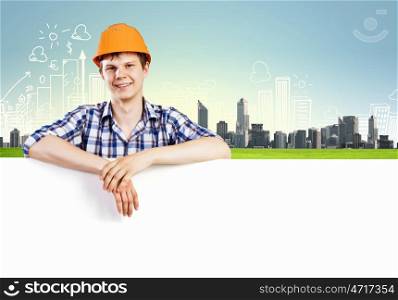 Man builder. Image of man engineer in helmet with blank banner