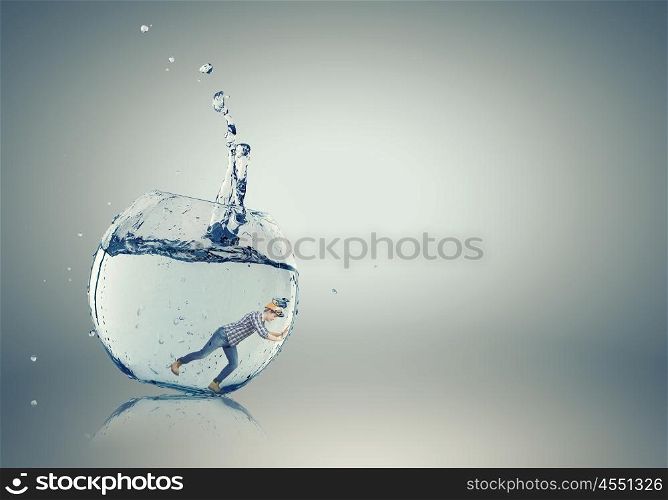 Man builder in aquarium. Young engineer man swimming in crystal blue water