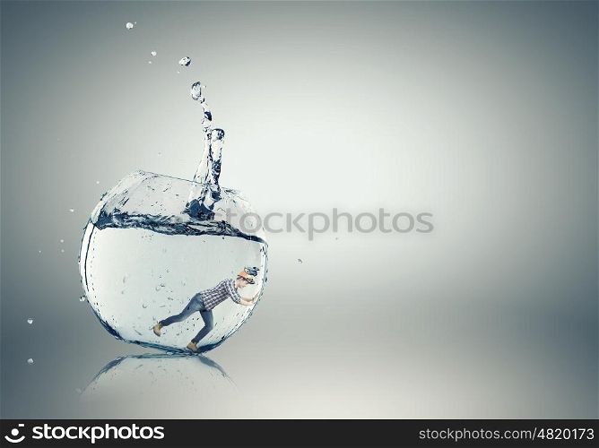 Man builder in aquarium. Young engineer man swimming in crystal blue water