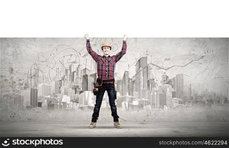 Man builder presenting something. Young smiling craftsman holding white blank banner above head