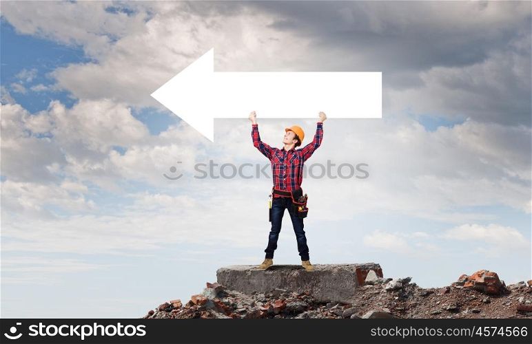 Man builder presenting something. Young smiling craftsman holding with blank banner. Place for text