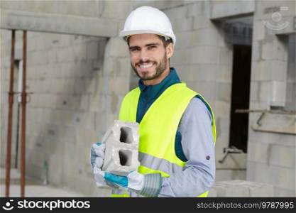 man builder working with bloc of cement
