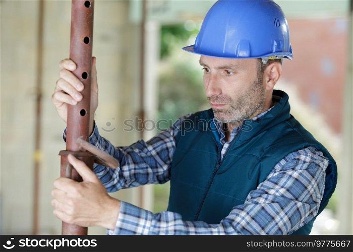 man builder working with pipes structure