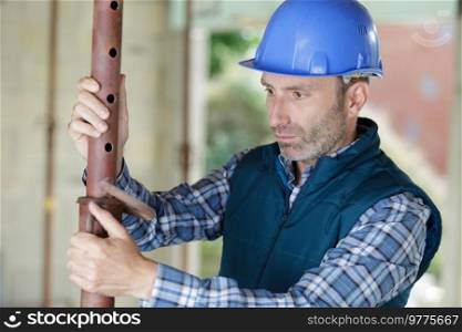 man builder working with pipes structure