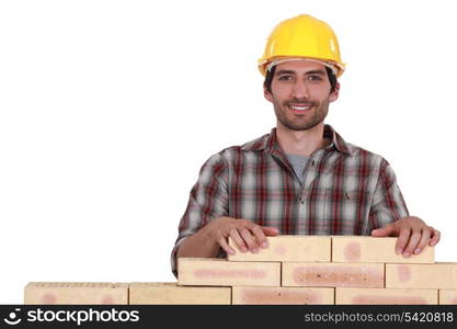 Man building brick wall