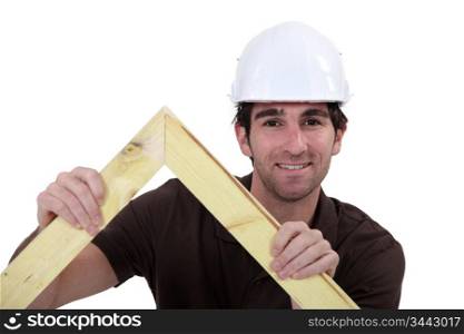 Man building wooden truss