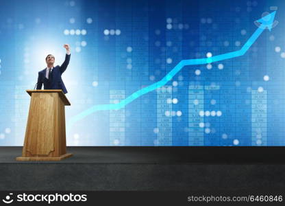 Man businessman making speech at rostrum in business concept