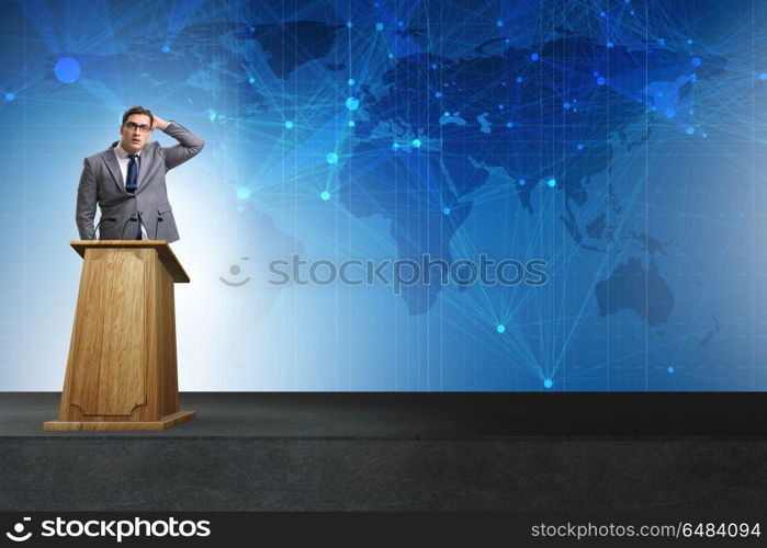 Man businessman making speech at rostrum in business concept