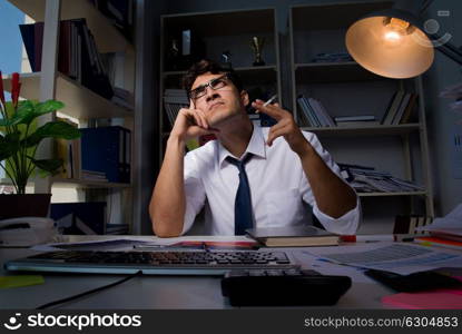 Man businessman working late hours in the office