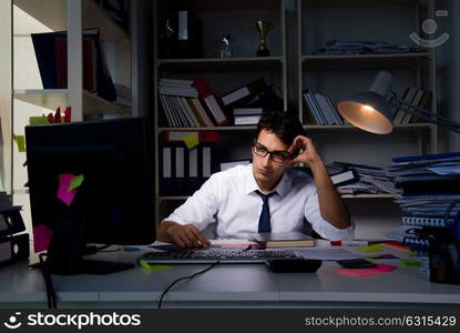 Man businessman working late hours in the office