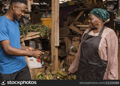 man buying food from market