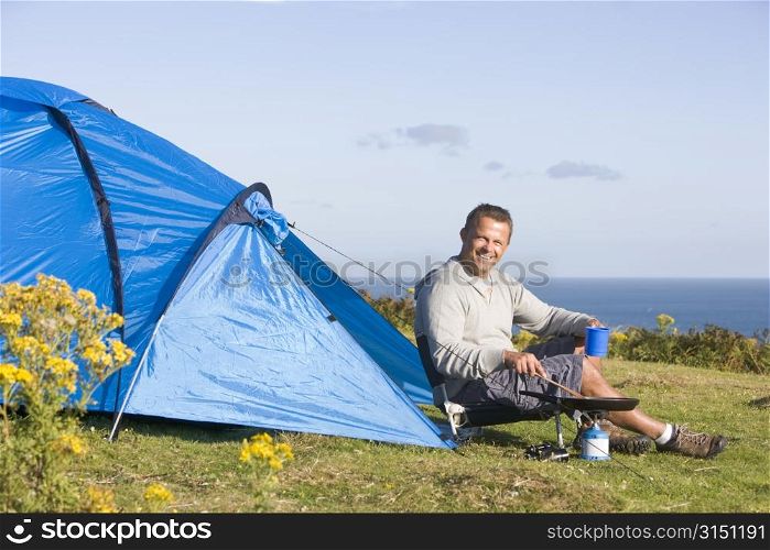 Man camping outdoors and cooking