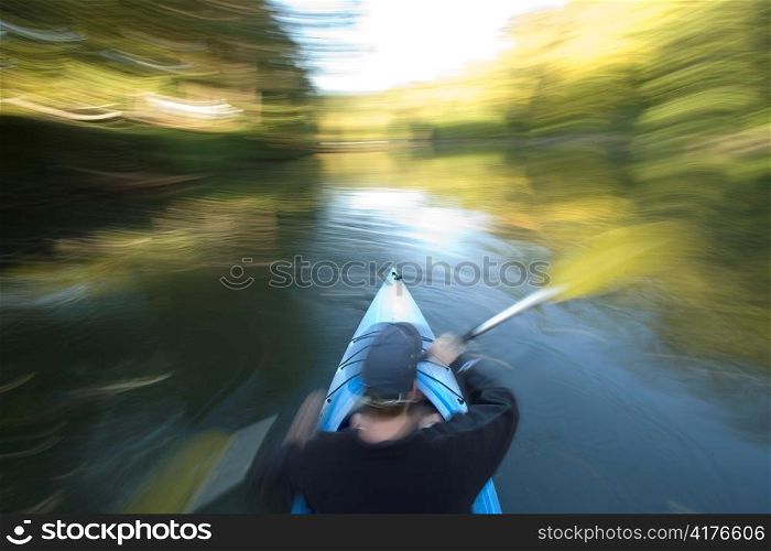 Man Canoeing with Blurry Leaves