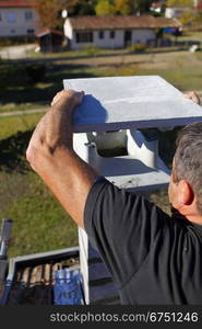 Man capping a chimney stack