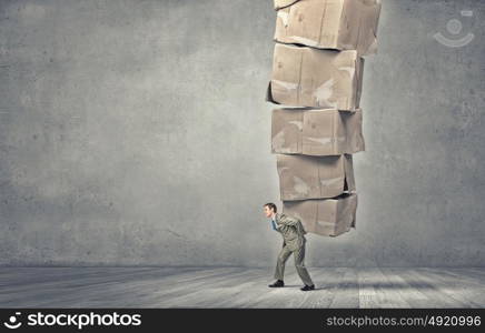 Man carry carton boxes. Young businessman in suit carrying big stack of carton boxes
