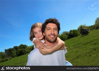 Man carrying a girl on his back