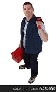 Man carrying a toolbox and a pipe wrench