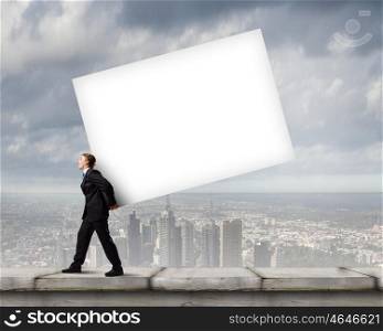 Man carrying banner. Young businessman carrying white blank banner on back