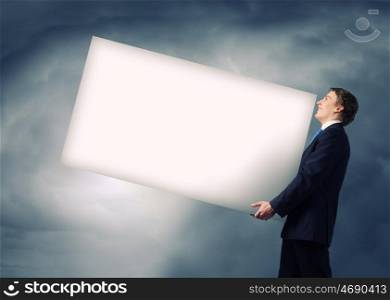 Man carrying banner. Young businessman carrying white blank banner. Place for text