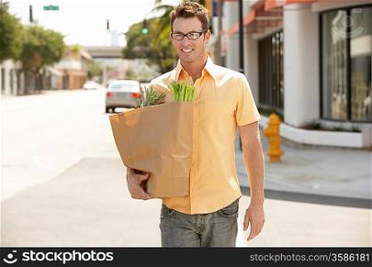 Man Carrying Groceries Home After Shopping