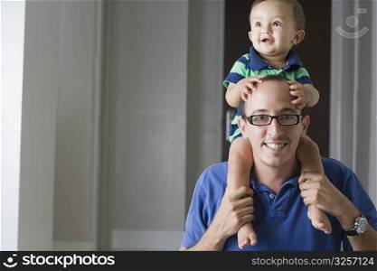 Man carrying his son on his shoulders