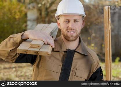 man carrying lumber