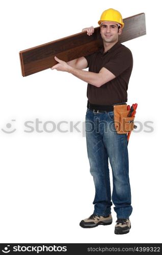 Man carrying parquet flooring