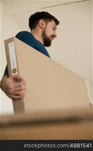 Man carrying stacked boxes on moving day