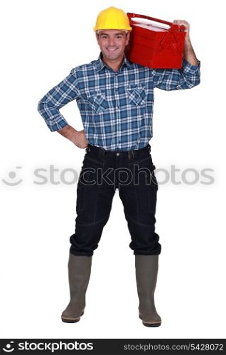 Man carrying tool box on shoulders