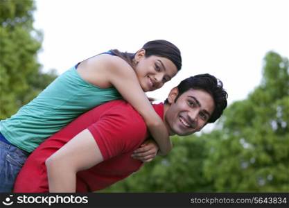 Man carrying woman on back