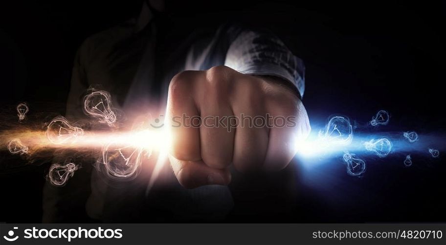 Man catch stream of light. Close up of businessman grasping light in fist