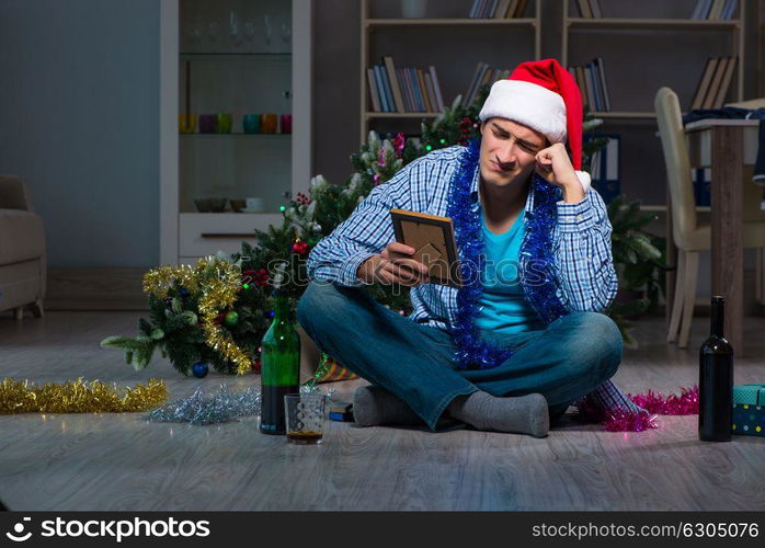 Man celebrating christmas at home alone. The man celebrating christmas at home alone