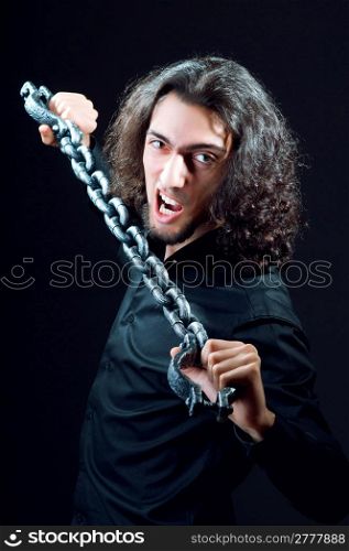Man chained in the dark room