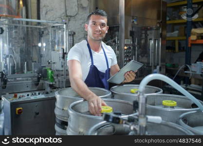 man checking beer in the factory